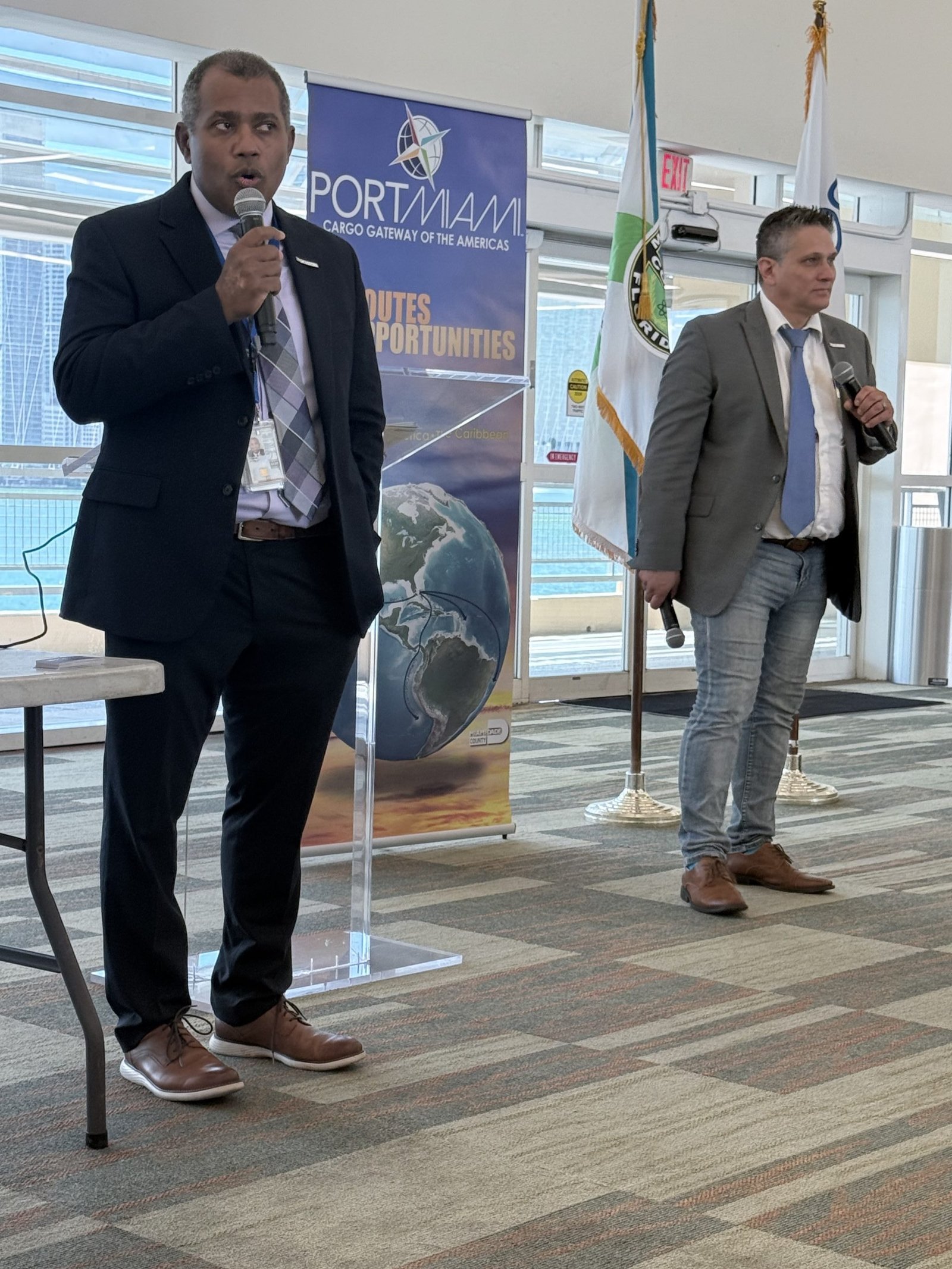 PortMiami officials briefing delegates beside a PortMiami banner.