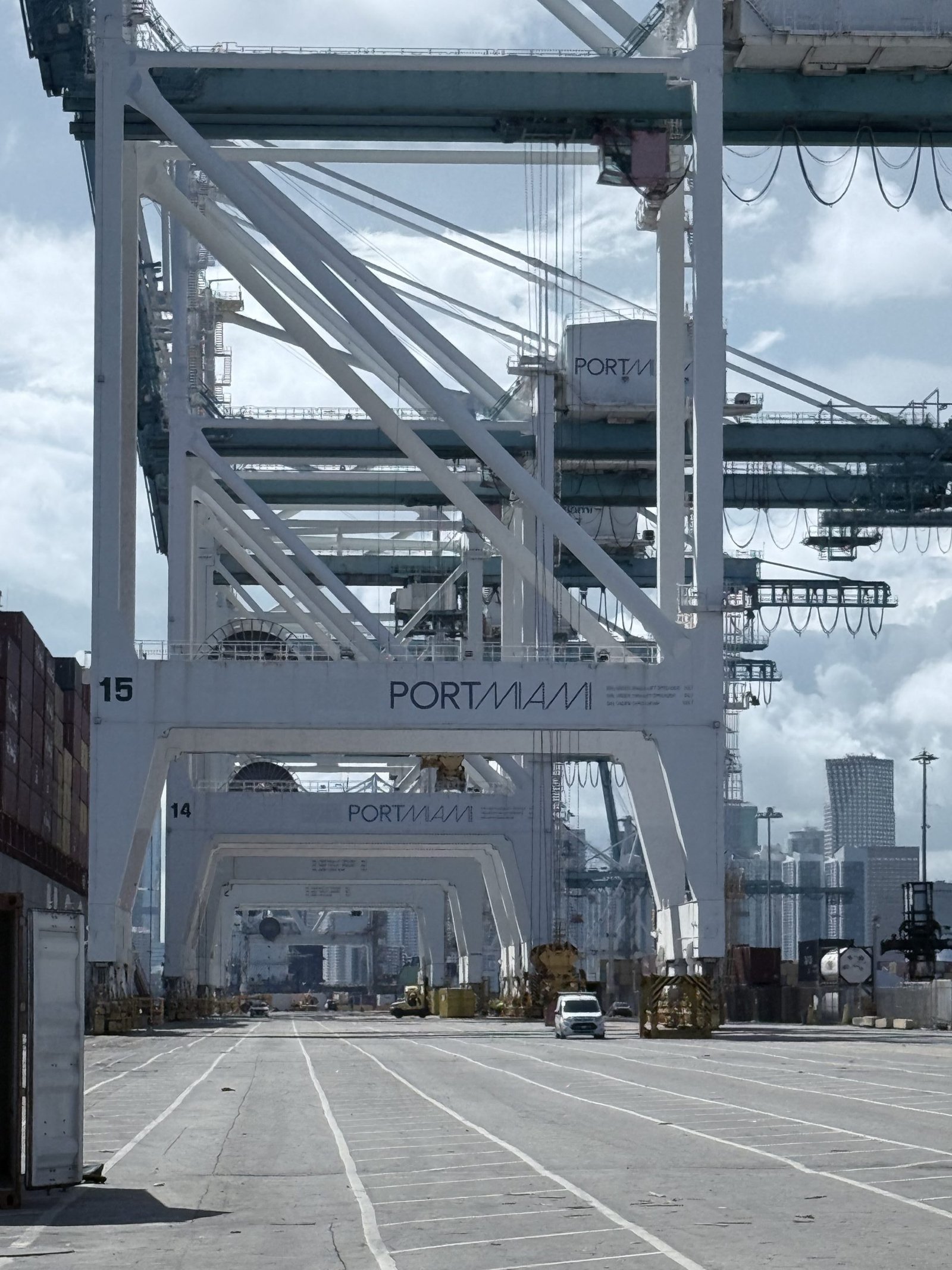 Ship-to-shore gantry cranes at PortMiami with the Miami skyline behind.