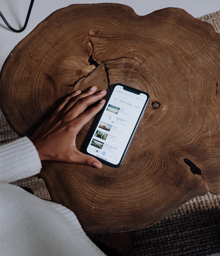 hand on phone on wooden table